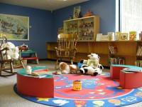 Photo of a children's play room with toys and a play mat