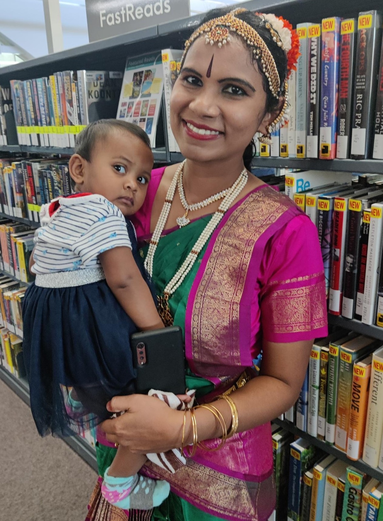 Mother holding baby during Diwali celebrations at John M. Harper Branch